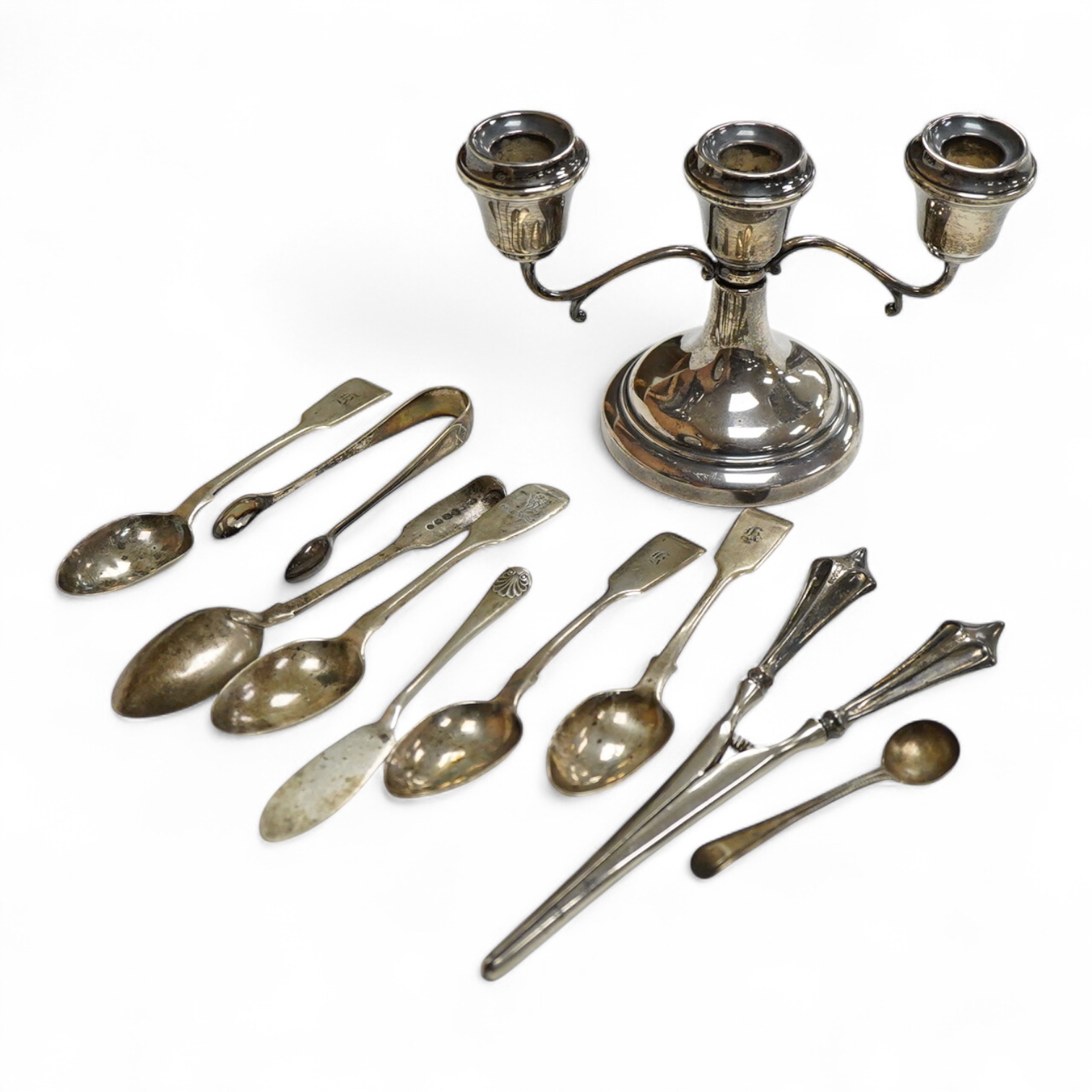 A small group of silver including a modern two branch, three light dwarf candelabrum by Sanders & Mackenzie, height 10.2cm, weighted, a pair of handled glove stretchers and eight small items of flatware.